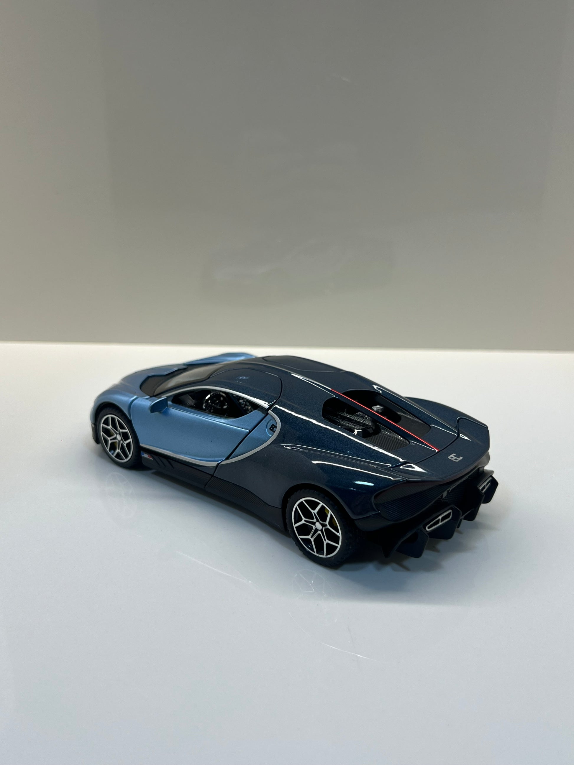 Maqueta a escala Bugatti Tourbillon azul vista trasera sobre fondo blanco